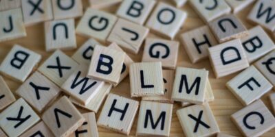 Powerful letters. Photo by Sven Brandsma on Unsplash. A set of wooden tiles with letters on them.