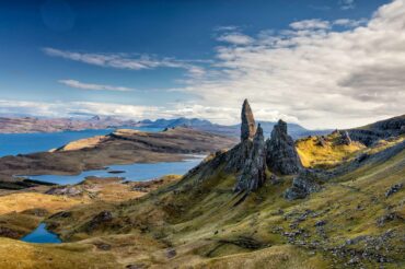 A mountain vista with lakes and rugged mountains jutting out of the landscape
