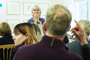 A picture of Nicola Davies engaging in a conversation with a member of the audience at the RENEW X BookTrust Biodiversity Storytelling Summit 2023.
