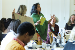 A picture of Smitri Halls engaging a group of people.