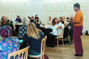 A picture of Anne Marie Anang delivering a presentation to an audience.
