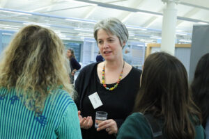 An image of three people holding a conversation.