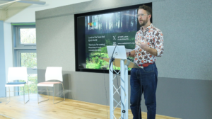 An image of poet Caleb Parkln delivering poetry to the Biodiversity Parliament audience 2023.