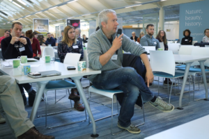 An image of Ilya Maclean talking to an audience at the Biodiversity Parliament 2023.