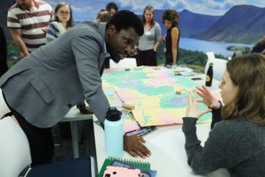 An image of PhD candidate Patrick Oku Quaye discussing research at the Biodiversity Parliament 2023.