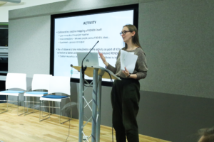 An image of Eleanor Hadley-Kershaw delivering research at the Biodiversity Parliament 2023.