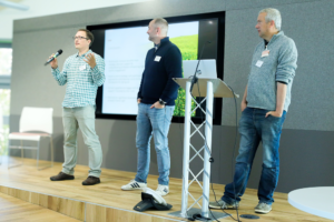 An image of David Baker, Charles Masqualier and Ilya Maclean delivering a presentation at the Biodiversity Parliament 2023.