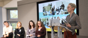 An image of researcher Regan Early delivering a research.